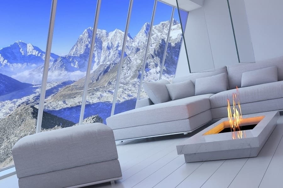 luxury experiences - beautiful living room with fireplace and snowy mountains