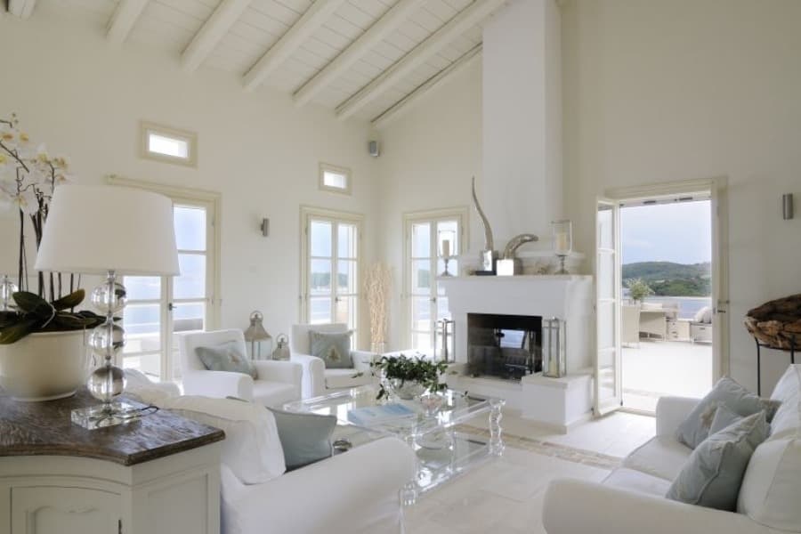 luxury villas - living room with white sofas and fireplace
