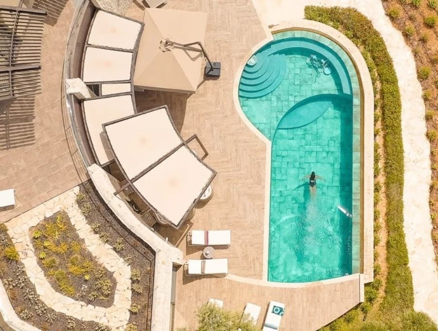 luxury villas - drone shot of pool with women swimming