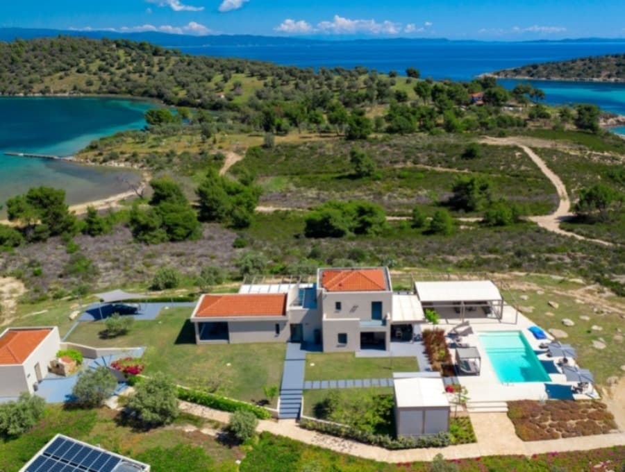 luxury villas - drone shot of villa with pool and sea view