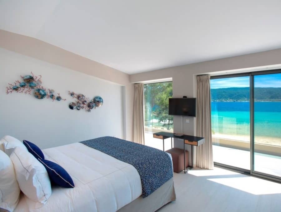 luxury villas - bedroom with double bed and balcony with sea view