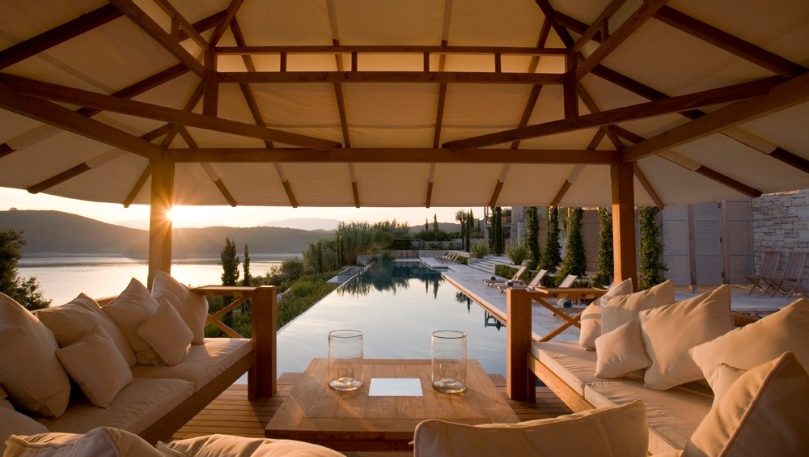 luxury villas - outside relaxing area with pool at sunset
