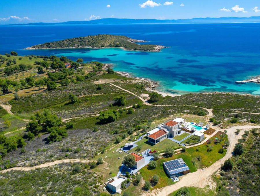 luxury villas - drone shot of villa at the sea