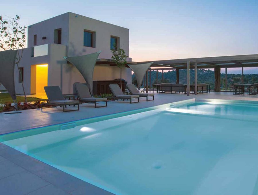 luxury villas - pool with sun beds at sunset