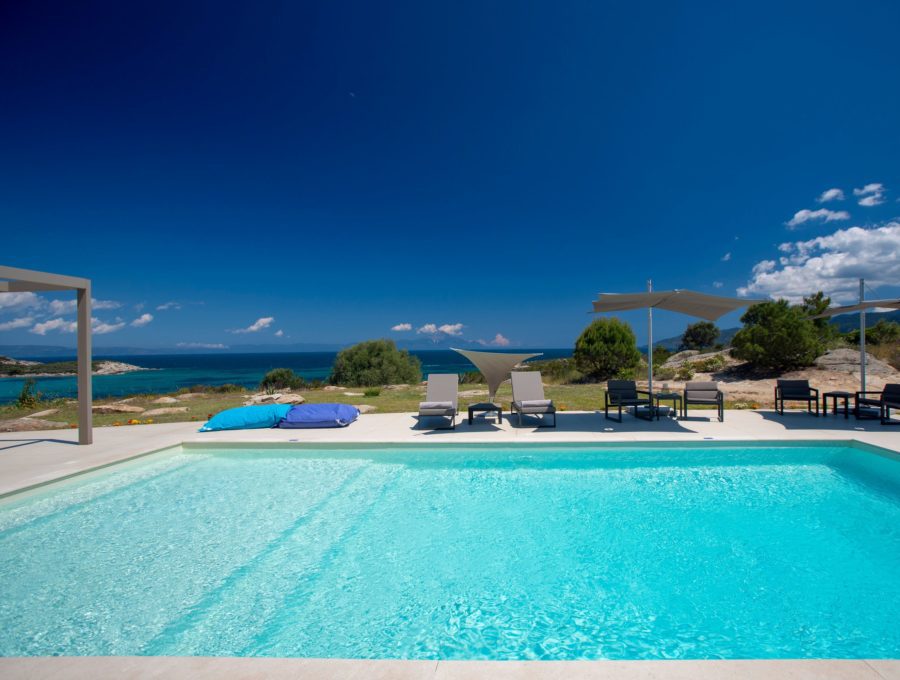 luxury villas - pool with sun beds and sea view