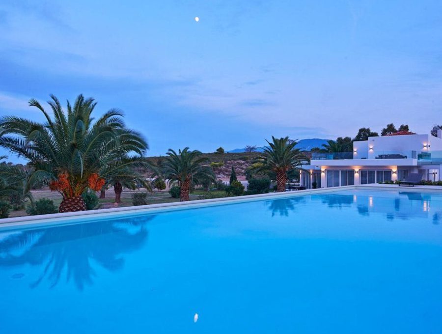 luxury villas - pool with villa by night