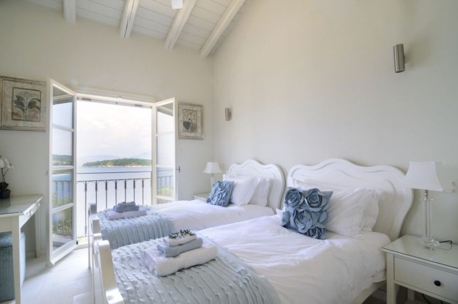 luxury villas - bedroom with two single beds and open door