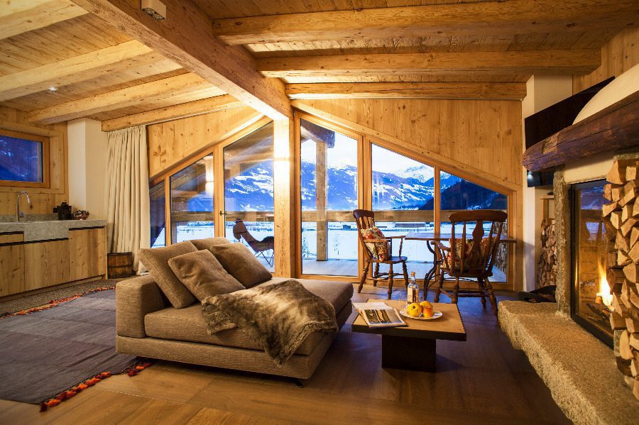 luxury villas - cosy living room of suite with large window and view to snowy landscape