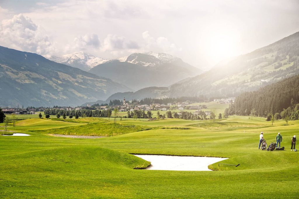 luxury villas - golf court with three golfers in beautiful landscape