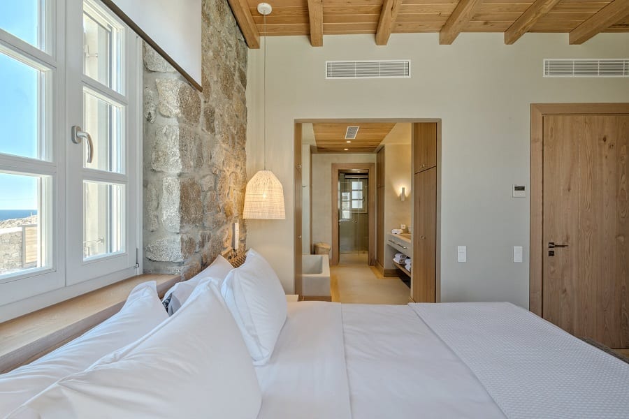 luxury villas - bedroom with double bed and view to the bathroom