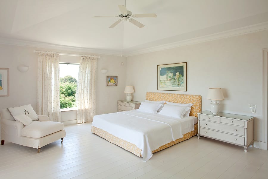luxury villas - bedroom with double bed and armchair