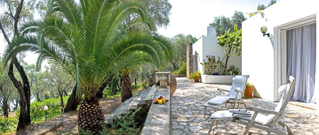 luxury villas - beautiful patio with 2 chairs surrounded by palm trees