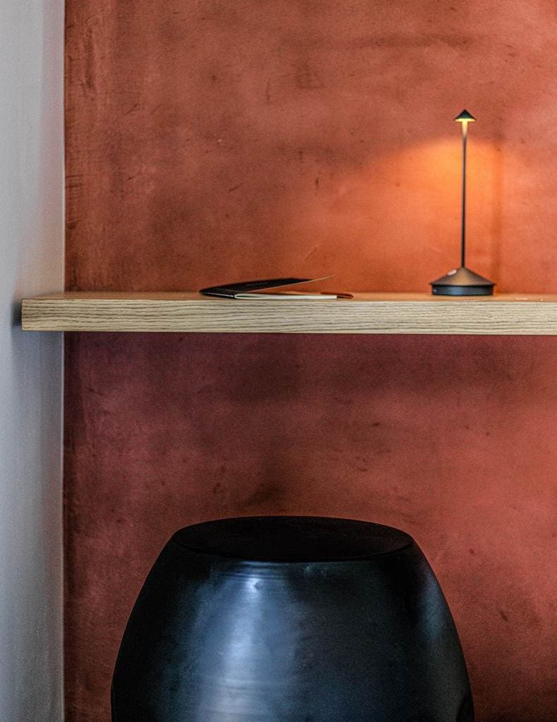 luxury villas - close up of orange wall with lamp and notebook