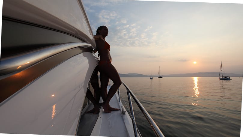 luxury yachts - women enjoying the sunset from deck