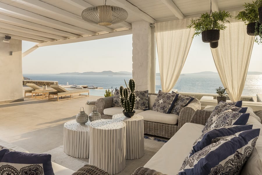 luxury villas - outside sitting area with sunbeds view of the pool and the sea