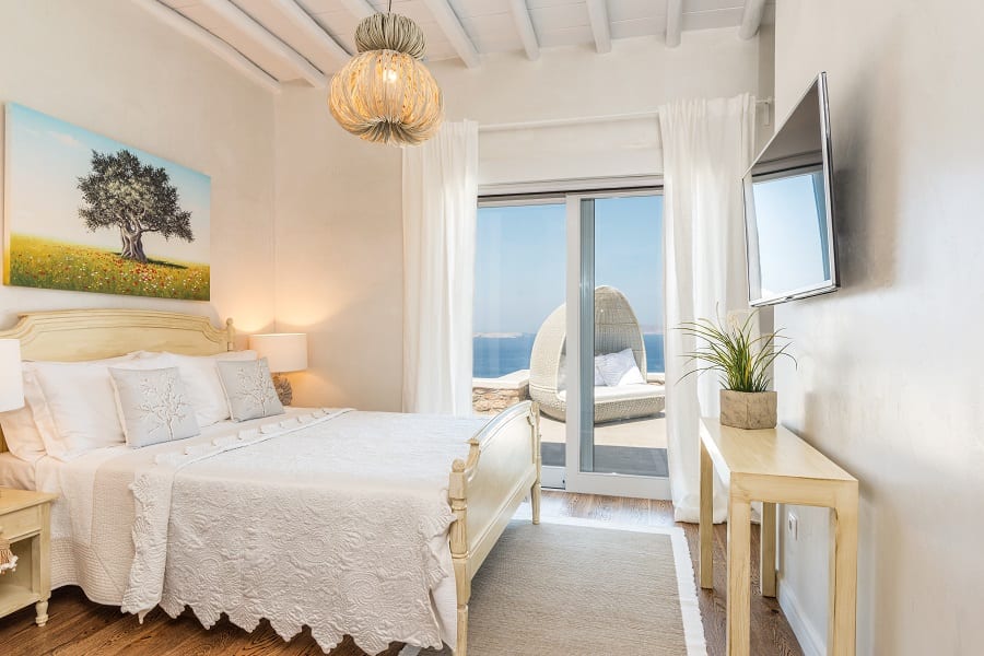 luxury villas - bedroom in bright colors with view on the terrace with seaview
