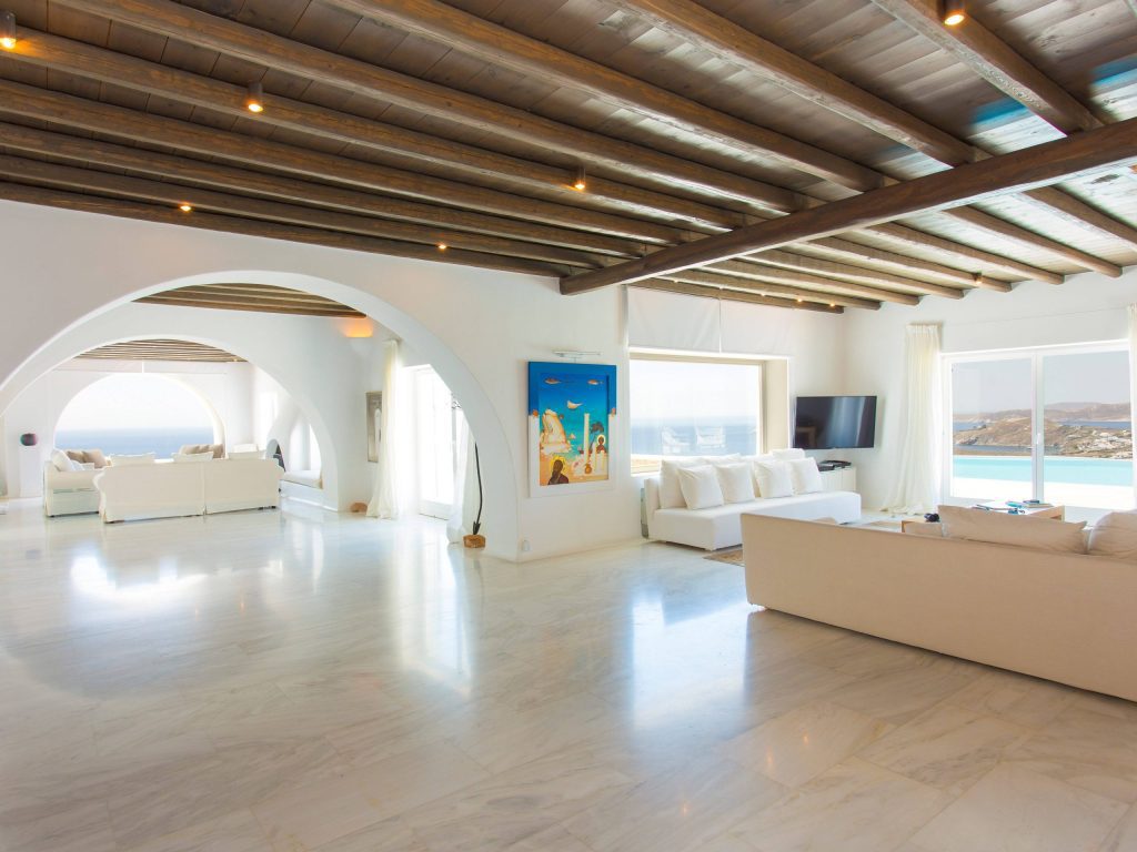 luxury villas - large indoor livingroom in bright colors with seaview