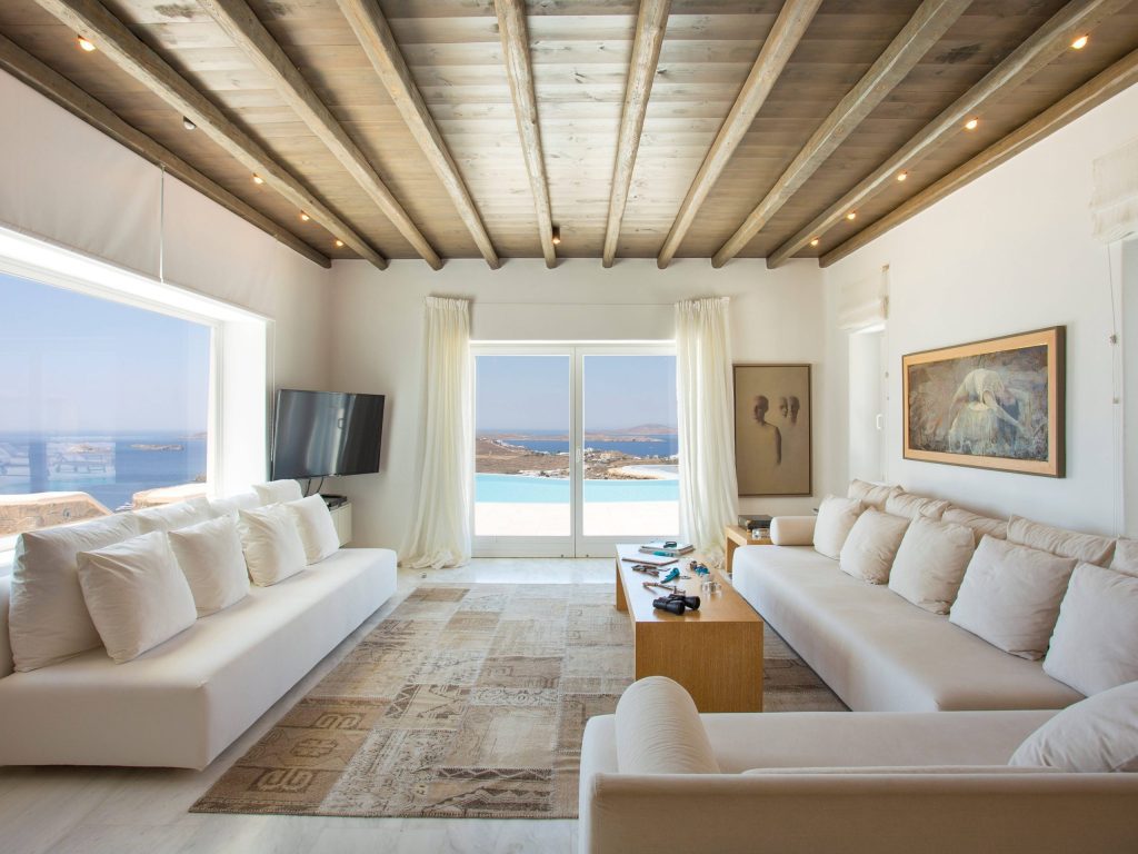 luxury villas - large indoor living room with 2 white sofas and seaview