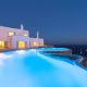 luxury villas - infinity pool by night and villa in the background