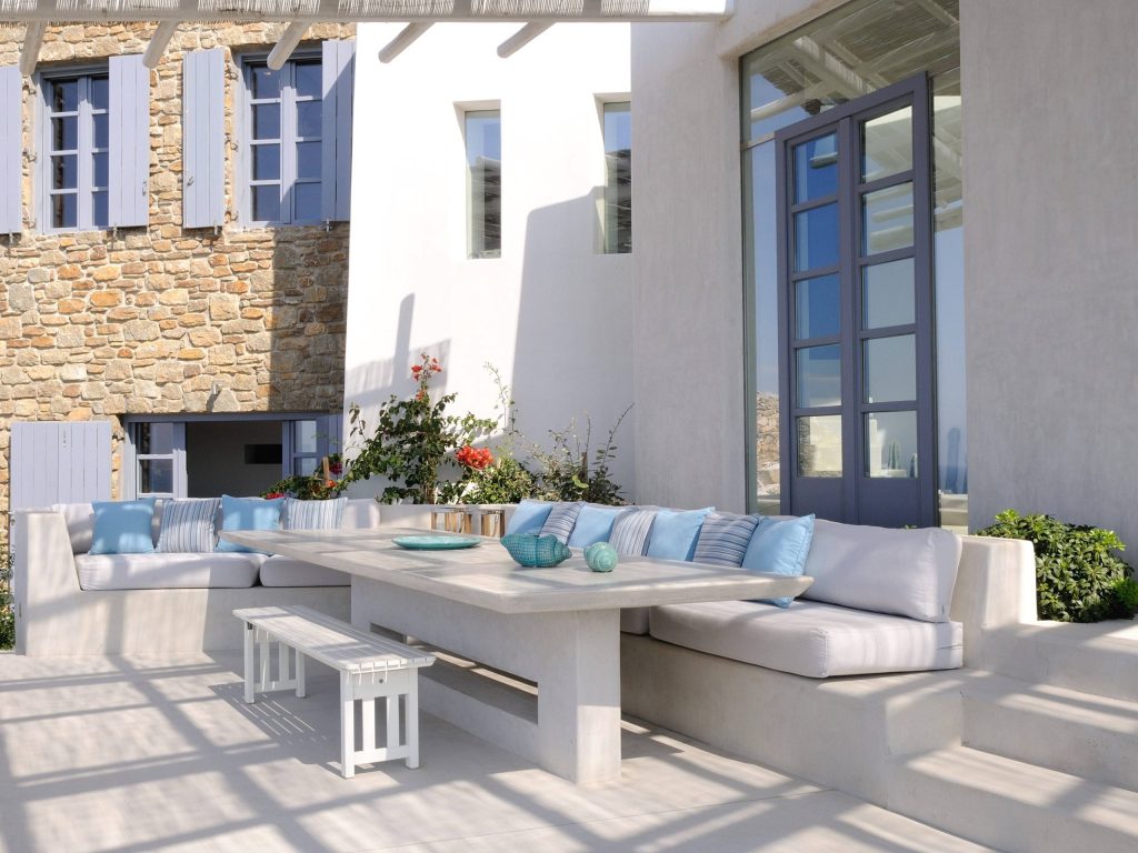 luxury villas - outside relax area with blue pillows and large table