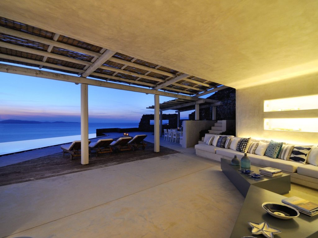 luxury villas - outside relax area with cosy light and seaview in the sunset