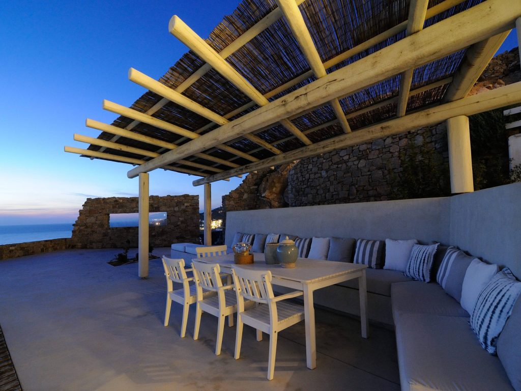 luxury villas - outside relaxing area with pillows in the sunset